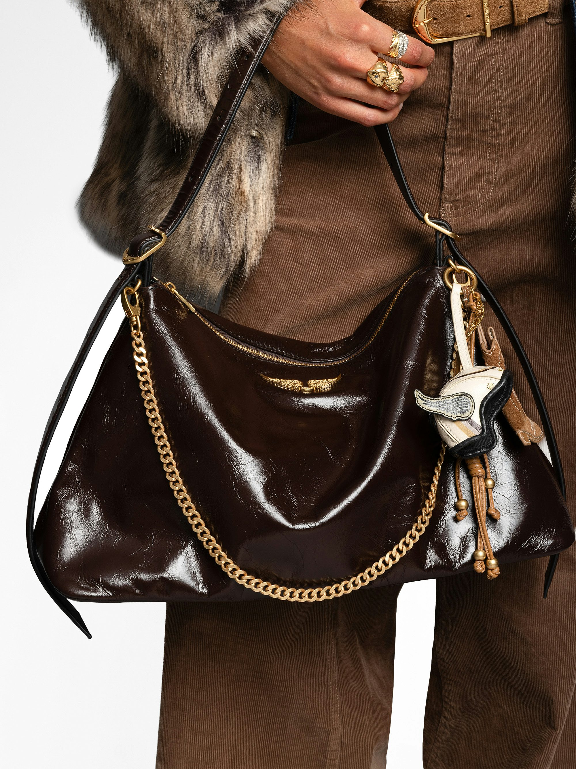 Jim Vintage Patent Bag - Soft leather bag with vintage effect adorned with a chain and a rhinestone wing.